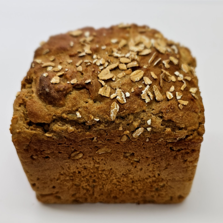 Ein goldbraunes Brötchen mit Haferflockenstreusel, das auf einem weißen Hintergrund platziert ist.